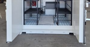 A large, white storage container with its side doors open up to reveal and interior with multiple shelving units.