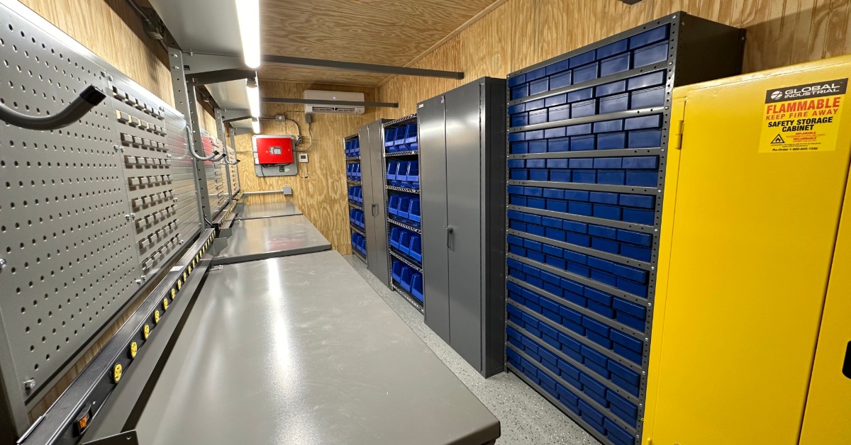 The inside of a wooden storage room. There are multiple storage lockers and drawers lining the walls.