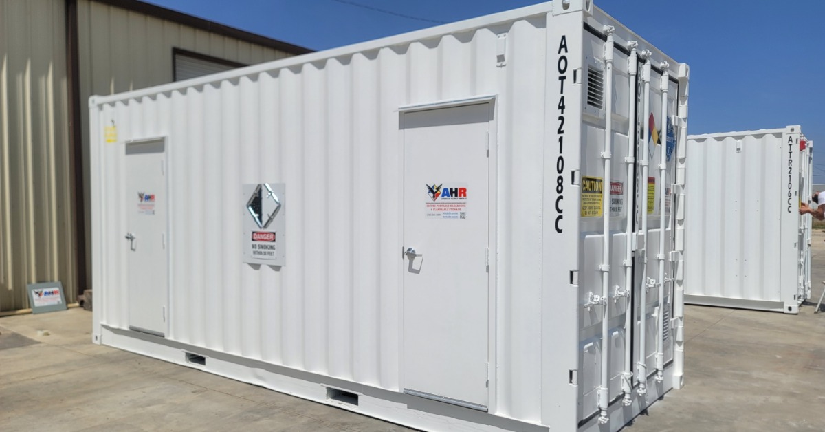 A single, small, white storage container. There are two small doors in the side of it to allow for access.